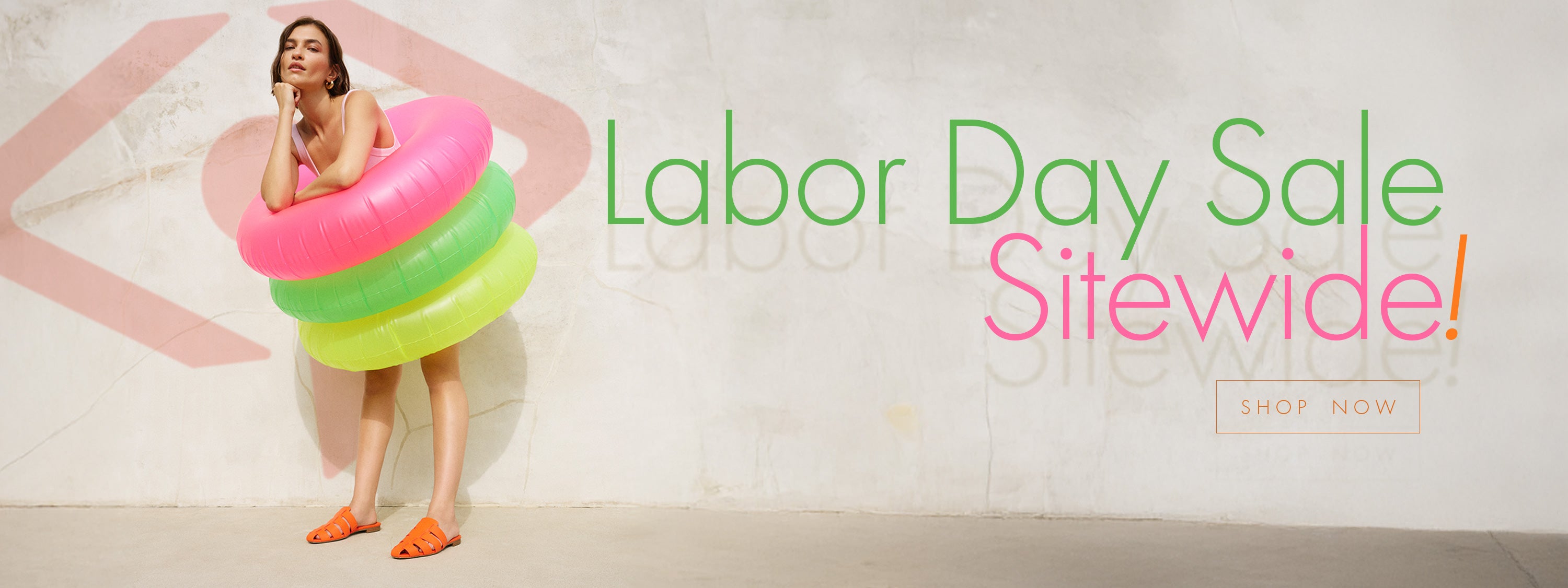 Woman with colorful inflatable rings and 'Labor Day Sale Sitewide!' text on a white background