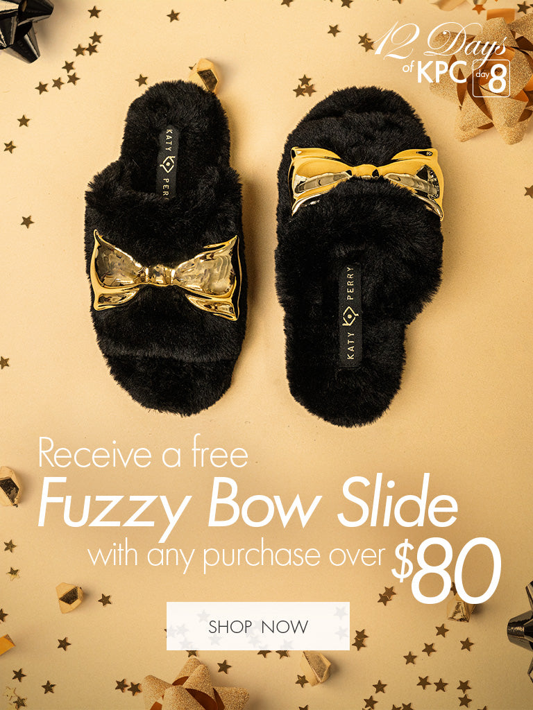 Black Fuzzy Slipper with gold bow.  Receive a Fuzzy Sipper with any purchase over $80