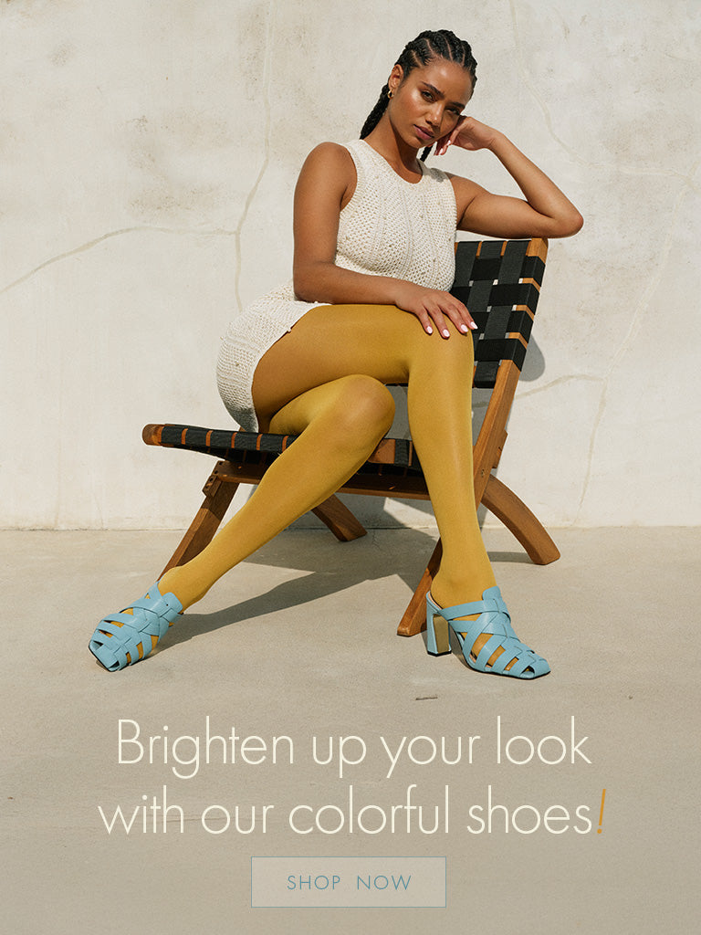 woman sitting on wood chair with yellow tights and a white knit dress with the copy Brighten up your look - shop now