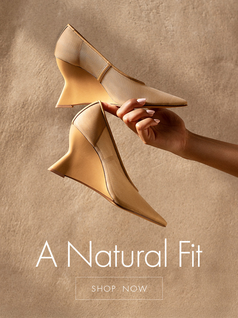 a beige wedge sandal being help up with the copy A Natural Fit shop now